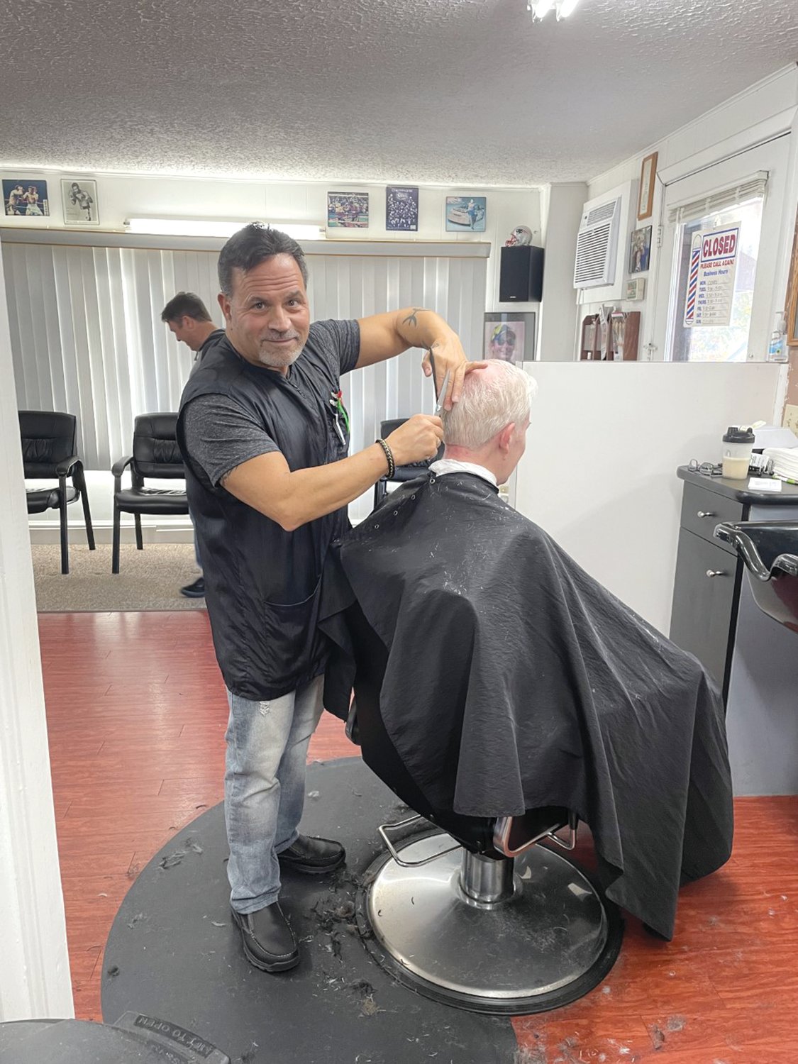 Dave Picozzi, the owner of David’s Greenwood Barber Shop, is seen here finishing up a cut on a customer who has been a loyal customer for over 14 years. David and his son Geno wish you and your families a happy, prosperous, and healthy New Year!